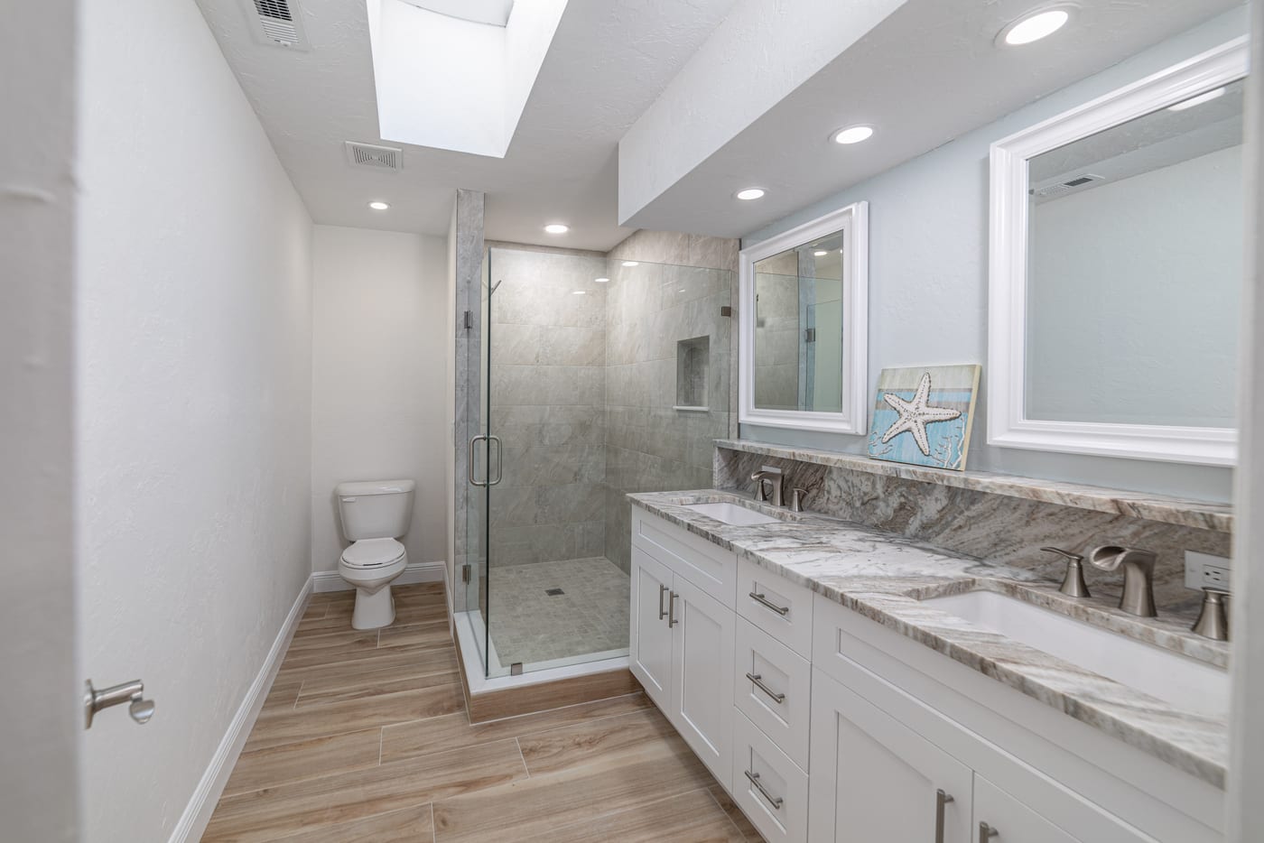 Primary bathroom with walk-in glass shower and double vanity